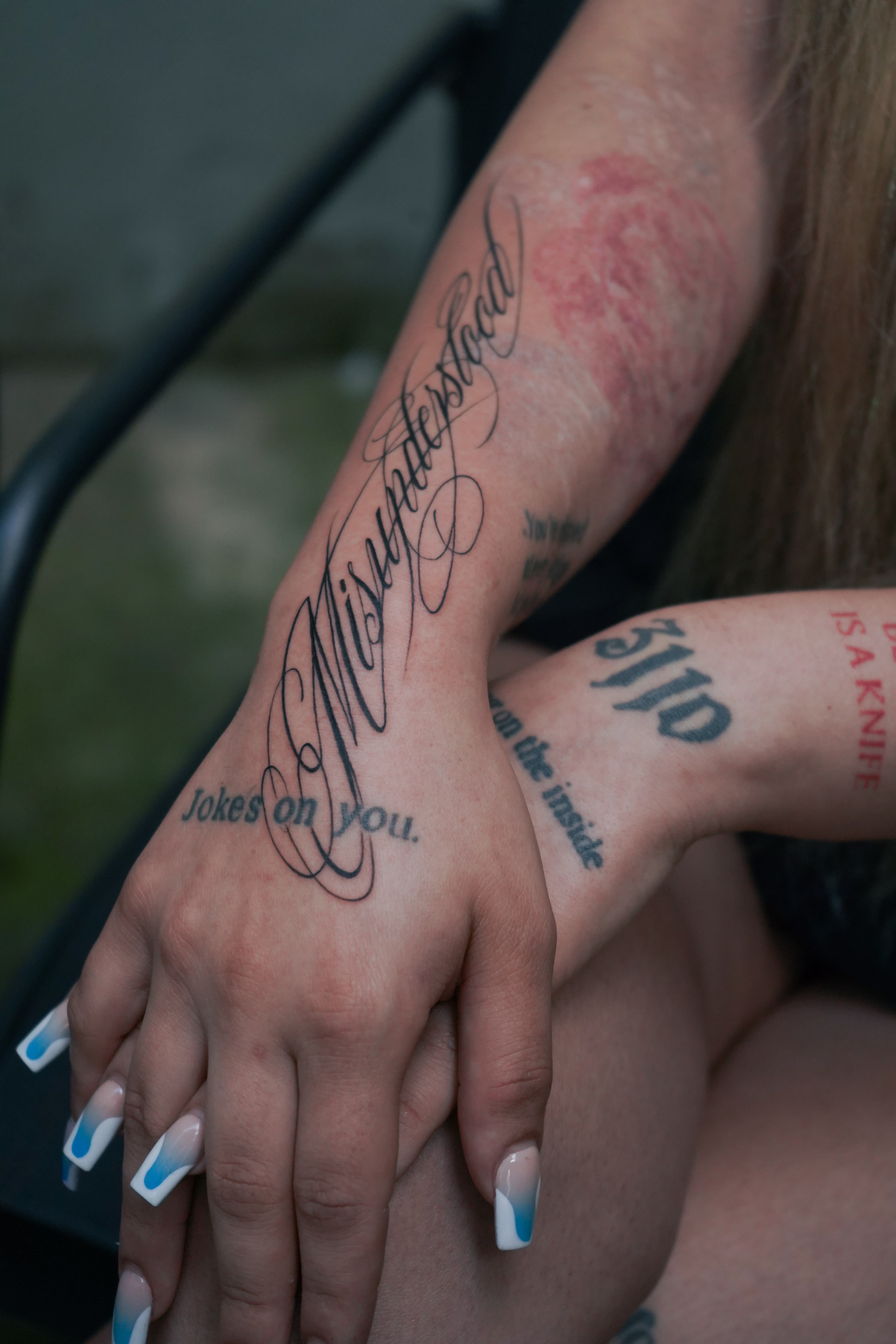 Fine line floral tattoo on inner forearm